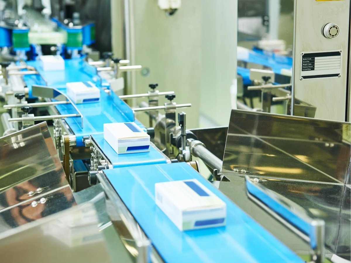 Pharmaceutical products moving along a conveyor belt on a packaging line